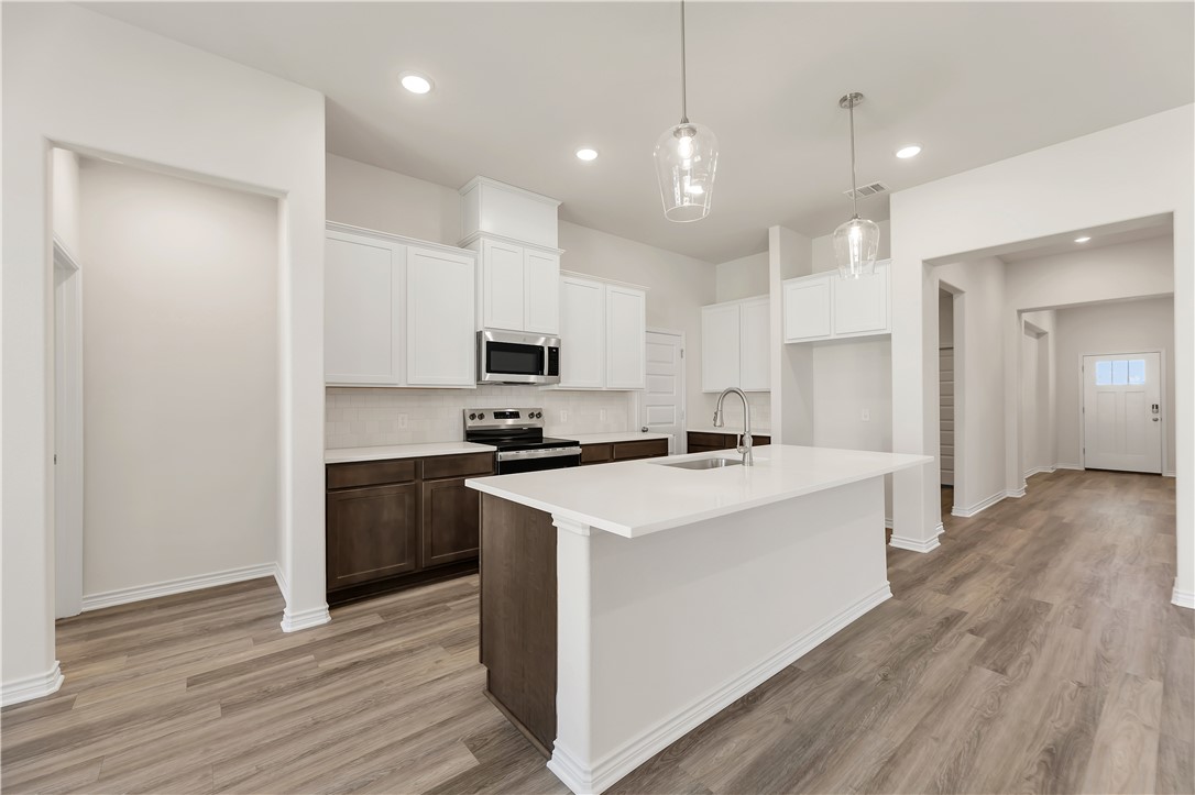 1931 Pinemont View Drive Bryan, TX 77807 - Photo 3 of 43 a kitchen with a sink a stove a refrigerator and a microwave