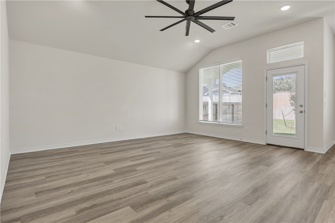 1931 Pinemont View Drive Bryan, TX 77807 - Photo 6 of 43 an empty room with wooden floor fan and windows