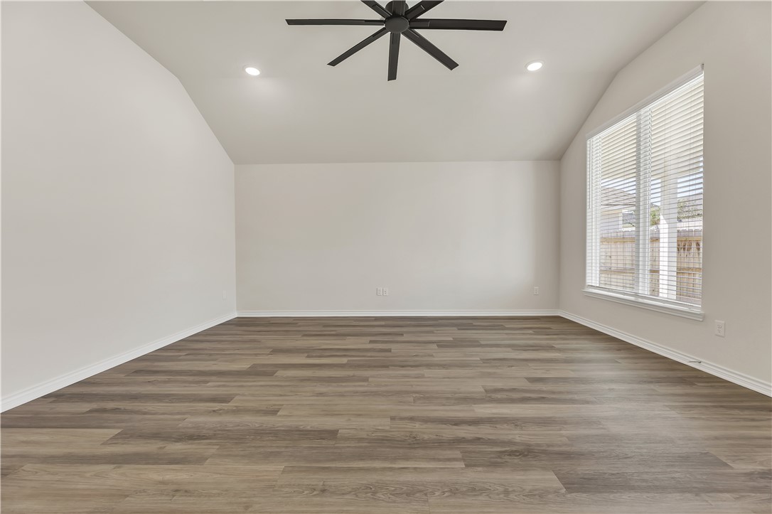 1931 Pinemont View Drive Bryan, TX 77807 - Photo 8 of 43 a view of an empty room with window and a ceiling fan