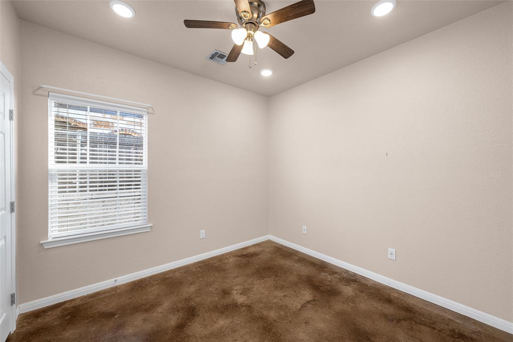 402 Spring Street McGregor, TX 76657 - Photo 12 of 16 an empty room with a window and a fan