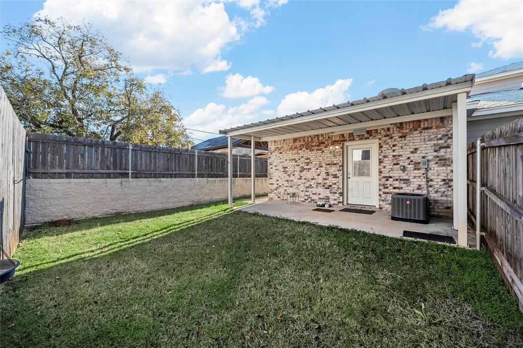 402 Spring Street McGregor, TX 76657 - Photo 14 of 16 a view of a backyard with a garden and entertaining space