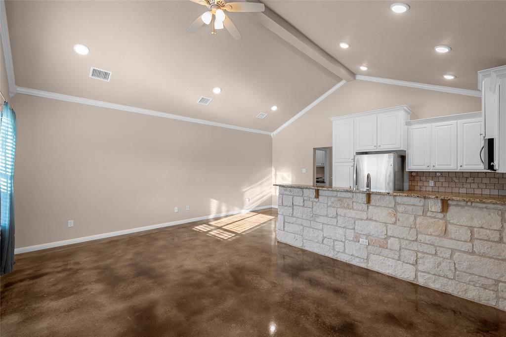 402 Spring Street McGregor, TX 76657 - Photo 3 of 16 a large kitchen with kitchen island a sink stainless steel appliances and cabinets