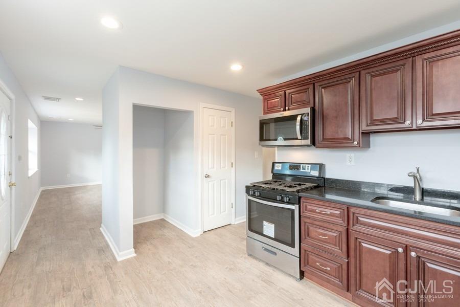 32 Winthrop Road Edison, NJ 08817 - Photo 4 of 15 a kitchen with stainless steel appliances granite countertop a stove a sink and a microwave