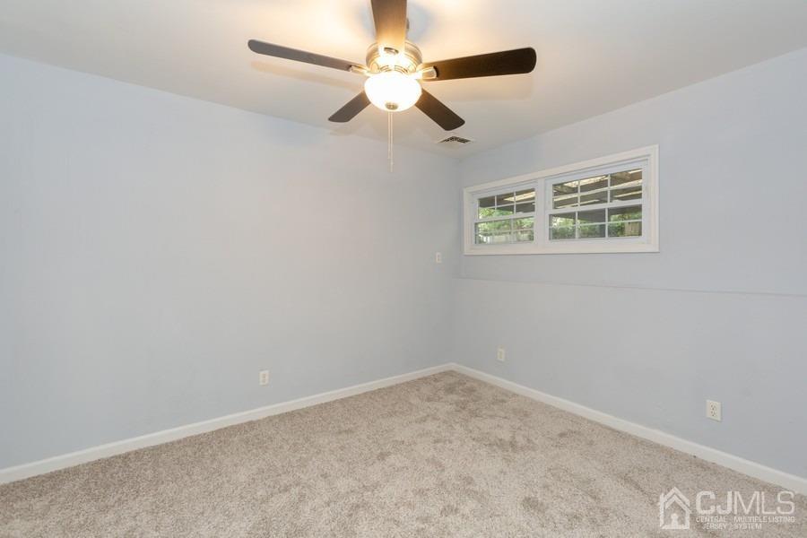 32 Winthrop Road Edison, NJ 08817 - Photo 6 of 15 an empty room with a window and a fan
