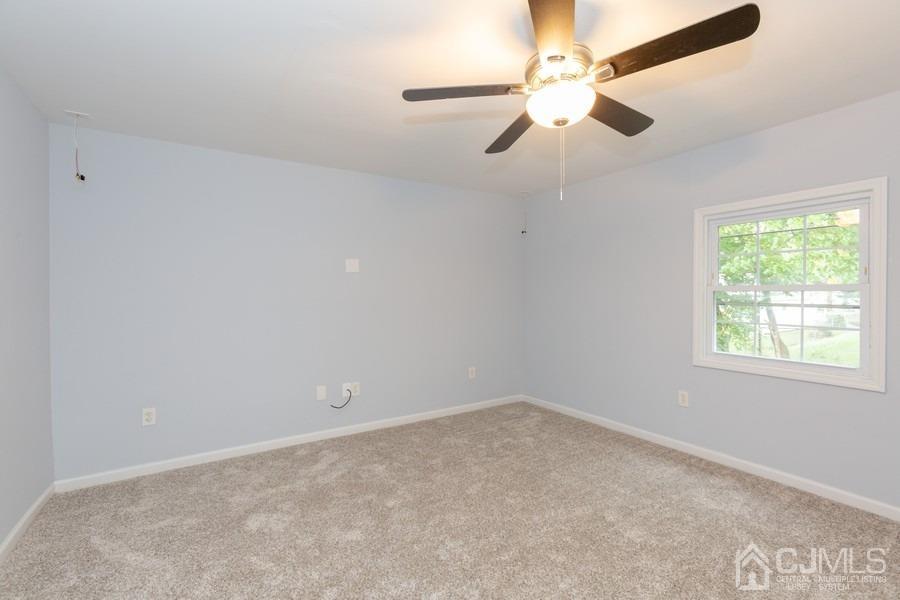 32 Winthrop Road Edison, NJ 08817 - Photo 8 of 15 an empty room with a window and a fan