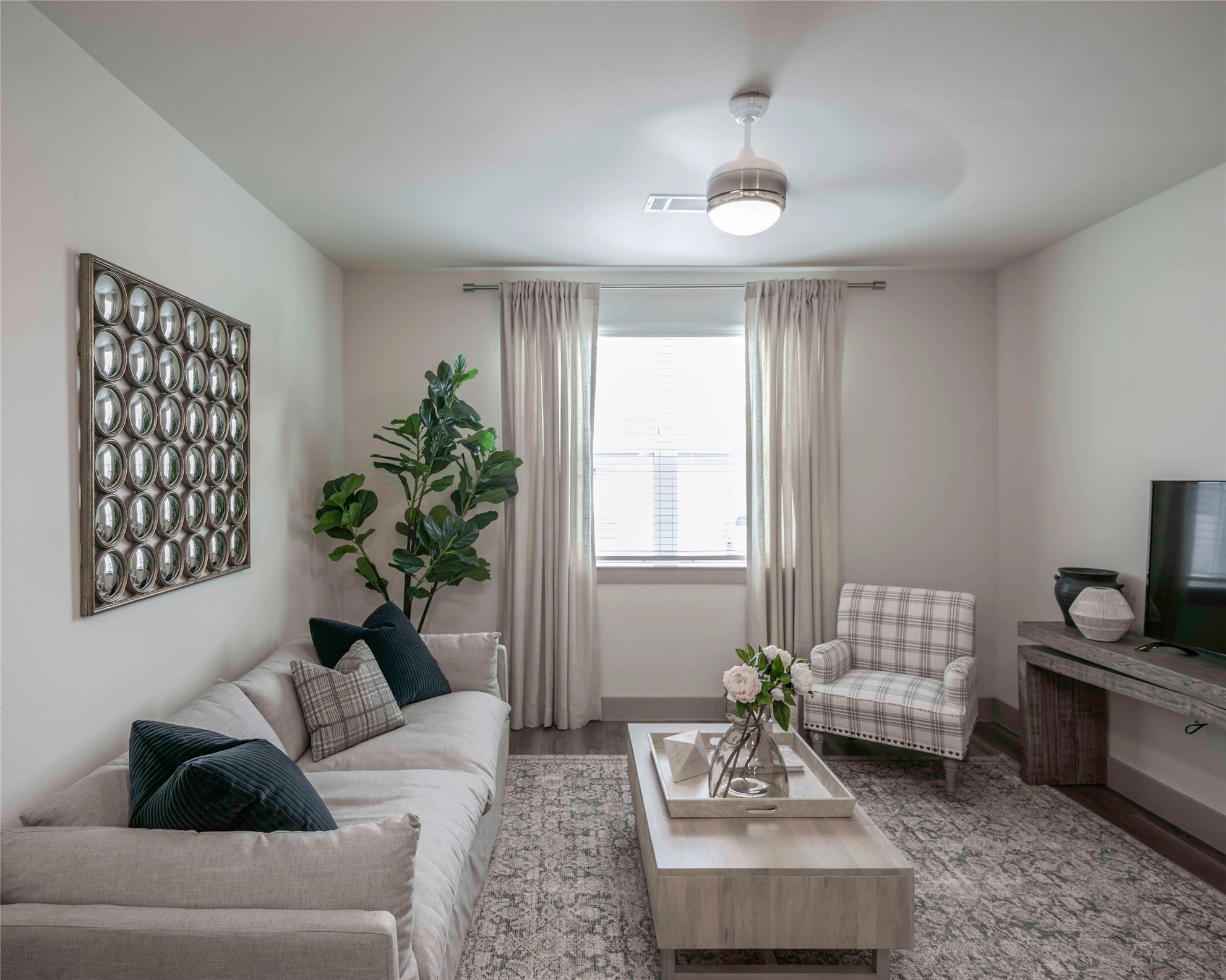 a living room with furniture and a chandelier