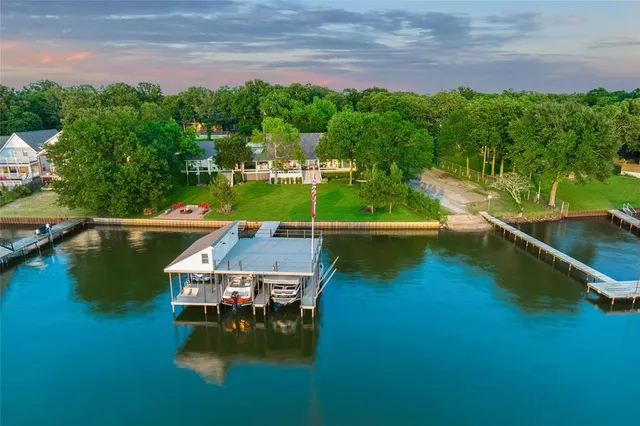 an aerial view of a house with swimming pool garden view and lake view