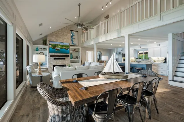 a view of a dining room with furniture a rug and wooden floor