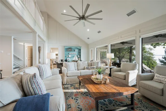 a living room with furniture ceiling fan and a large window