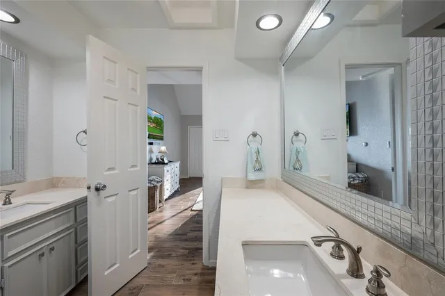 a spacious bathroom with a sink and a mirror