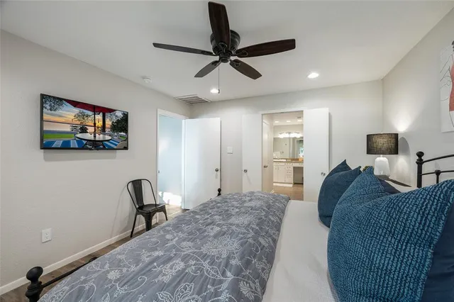 a living room with furniture and a ceiling fan