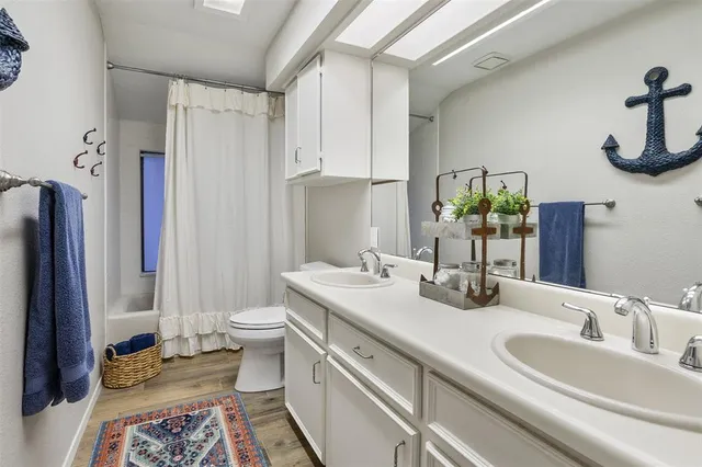 a bathroom with a double vanity sink and a mirror
