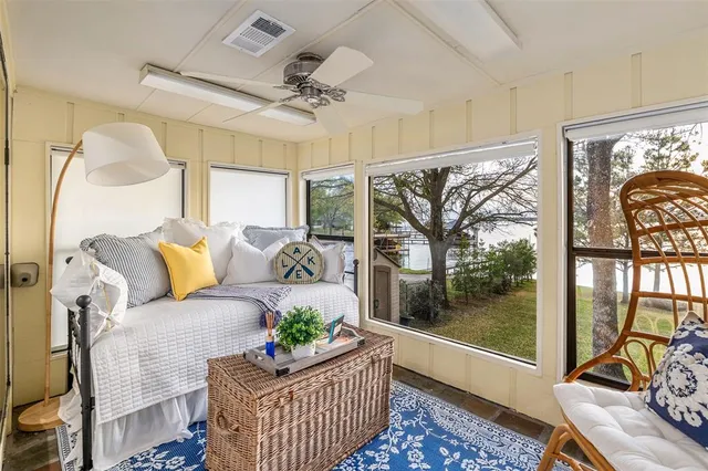 a living room with furniture and a floor to ceiling window