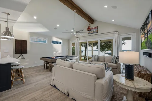 a living room with furniture a flat screen tv and a table