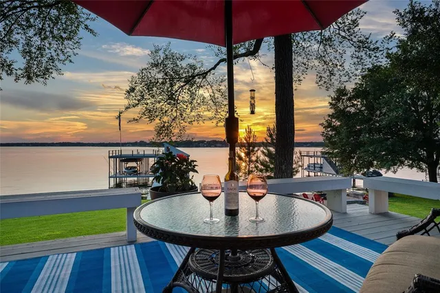 a view of a balcony with table and chairs under an umbrella