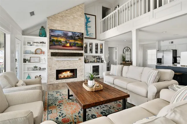 a living room with furniture kitchen view and a fireplace