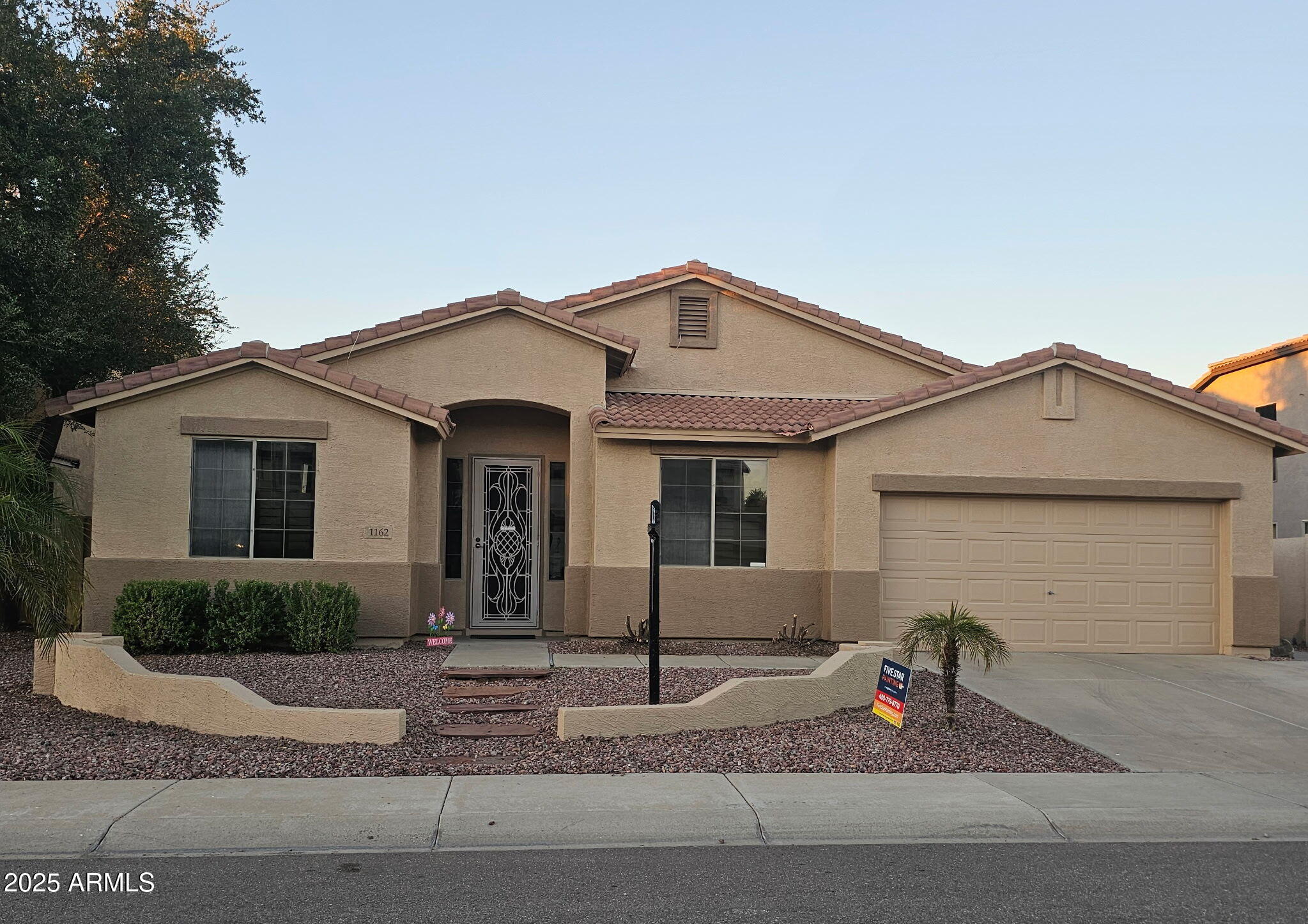 1162 East Springfield Place Chandler, AZ 85286 - Photo 1 of 27 a front view of a house with garden
