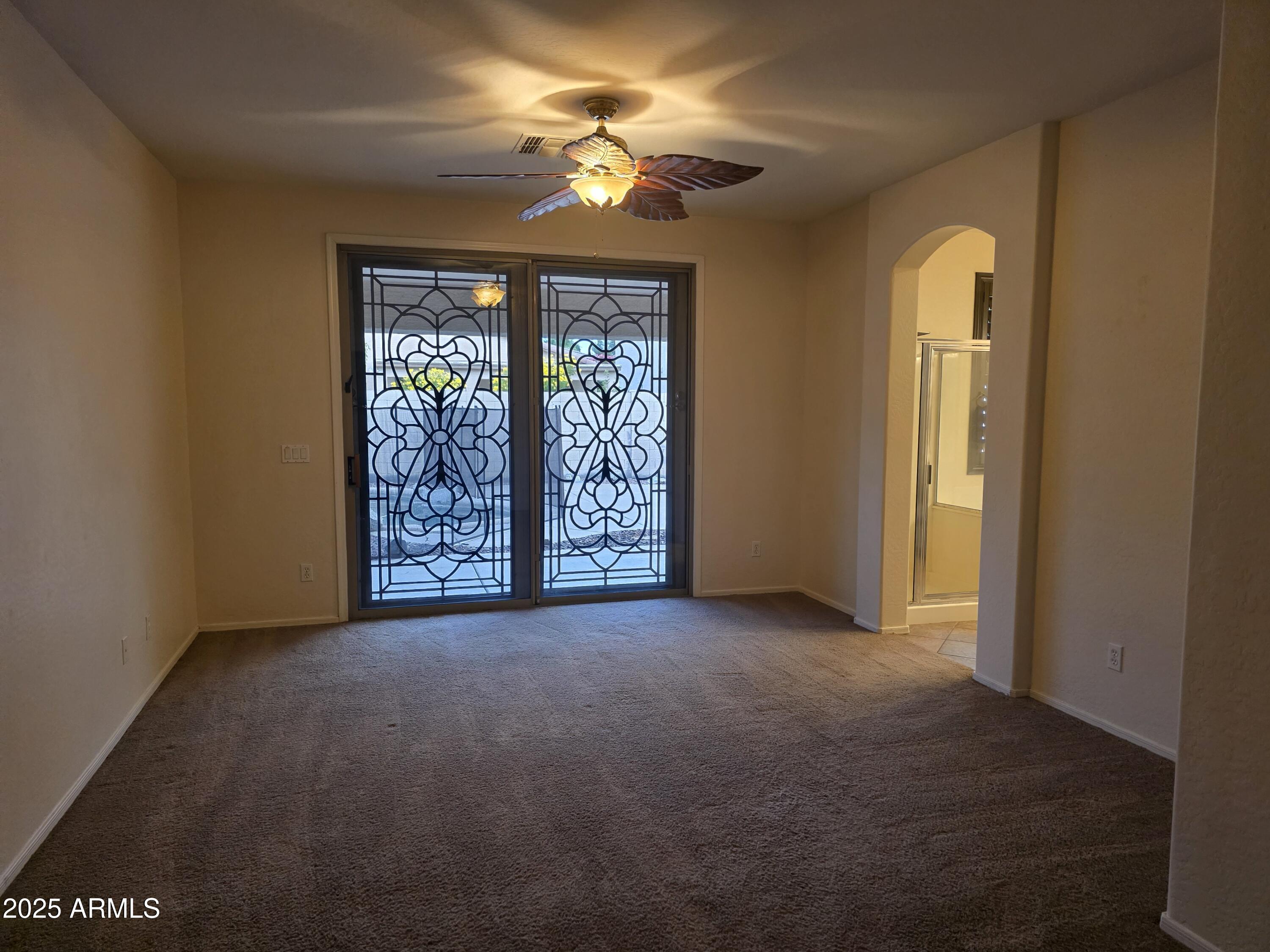 1162 East Springfield Place Chandler, AZ 85286 - Photo 13 of 27 an empty room with windows and fan