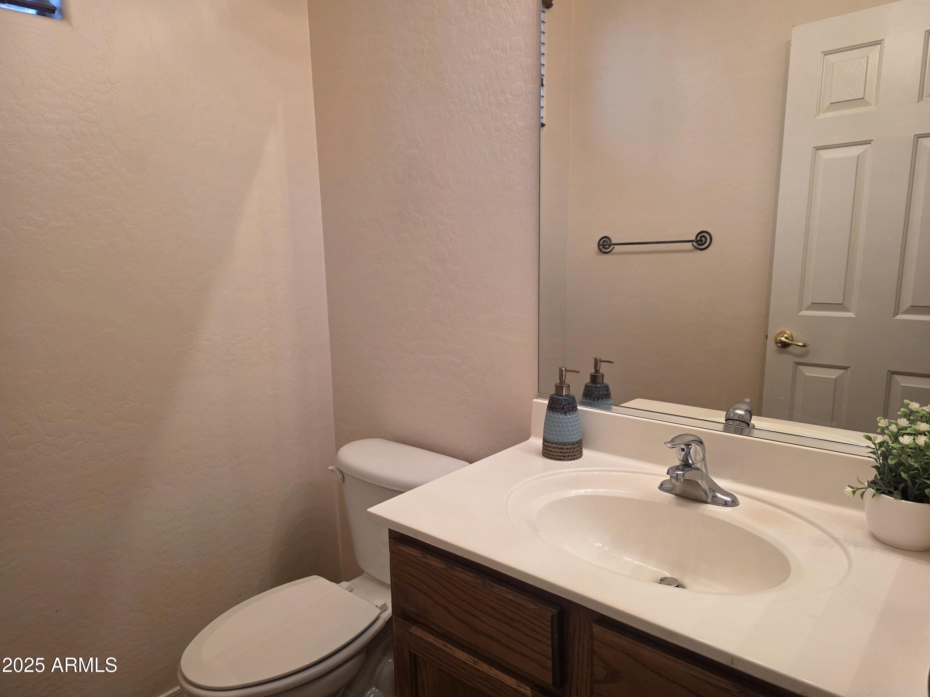 1162 East Springfield Place Chandler, AZ 85286 - Photo 4 of 27 a bathroom with a sink a toilet