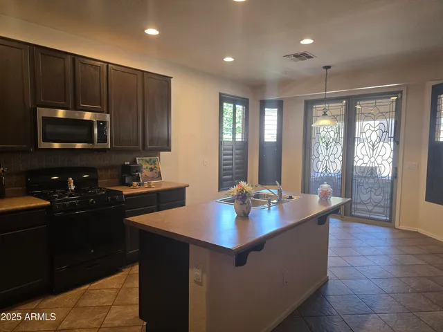 a kitchen with sink cabinets and microwave