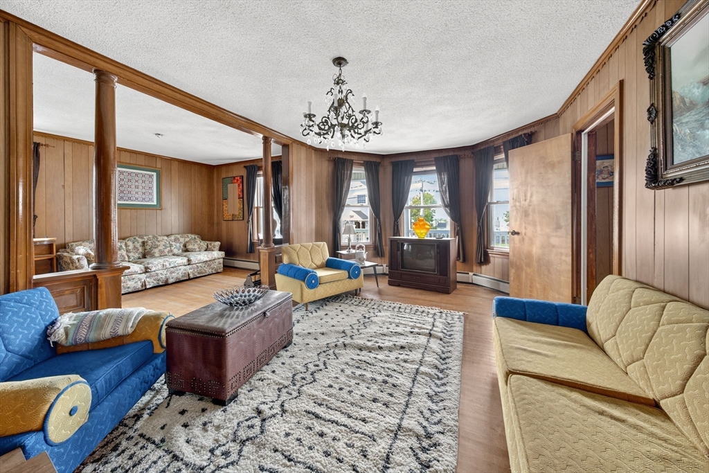 484 South Beach Street Fall River, MA 02724 - Photo 14 of 25 a living room with furniture or couch and a chandelier