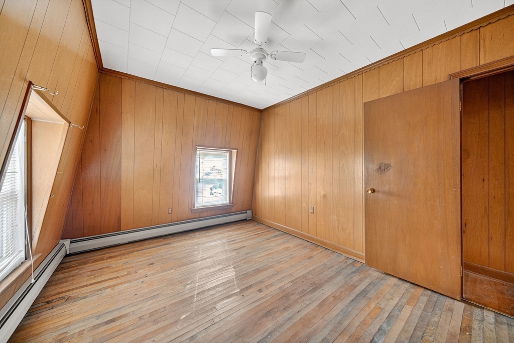 484 South Beach Street Fall River, MA 02724 - Photo 25 of 25 an empty room with wooden floor and a ceiling fan