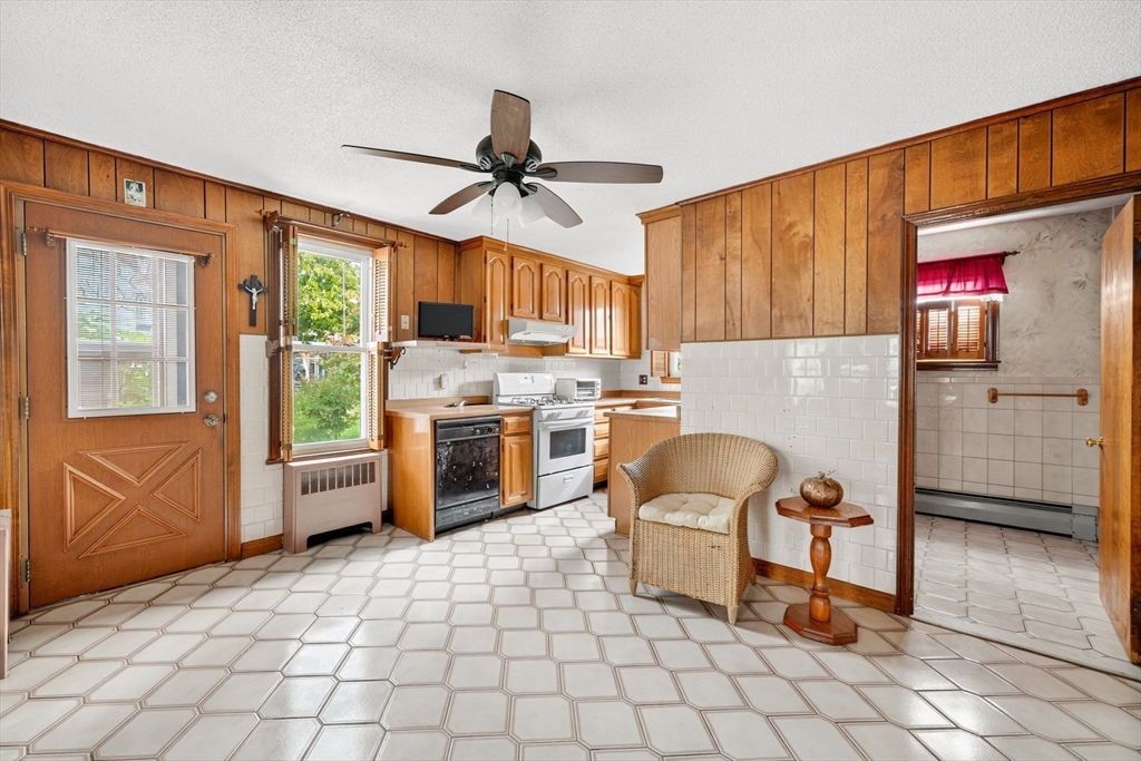 484 South Beach Street Fall River, MA 02724 - Photo 5 of 25 a kitchen with stainless steel appliances granite countertop a refrigerator sink and cabinets