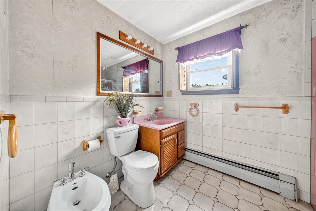 484 South Beach Street Fall River, MA 02724 - Photo 9 of 25 a bathroom with a toilet sink and mirror