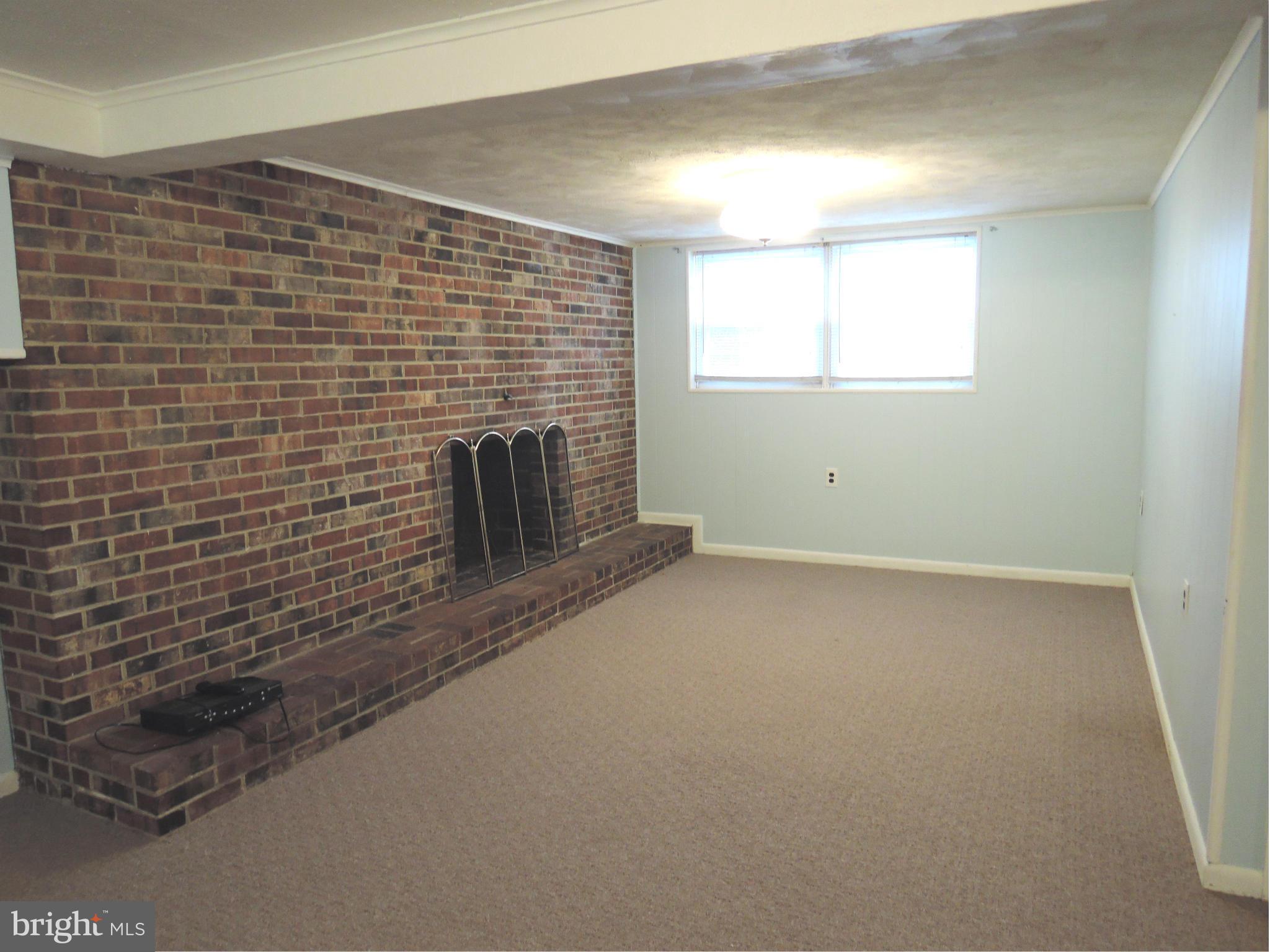 229 Arundel Road Pasadena, MD 21122 - Photo 13 of 23 Rec. Room with wood burning fireplace