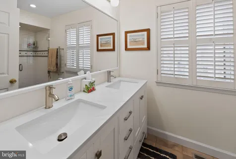 a bedroom with a bed and a lamp with the dresser