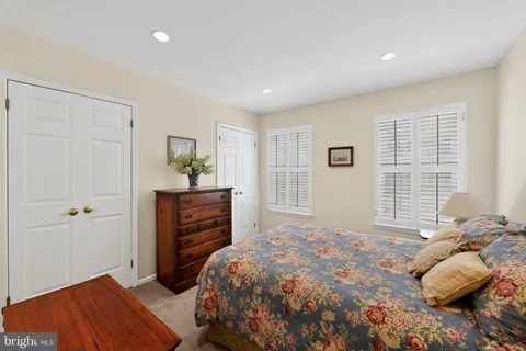 a bedroom with a bed and a mirror