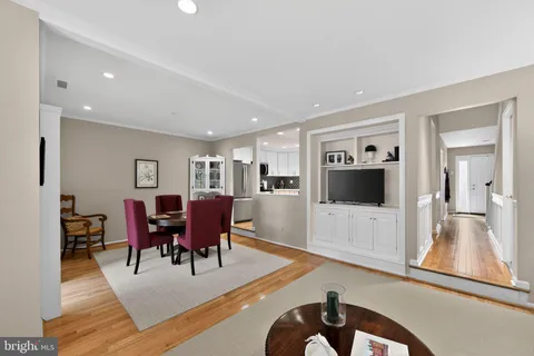 a dining room with furniture and wooden floor