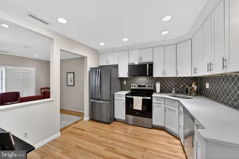 a view of a dining room with furniture and wooden floor