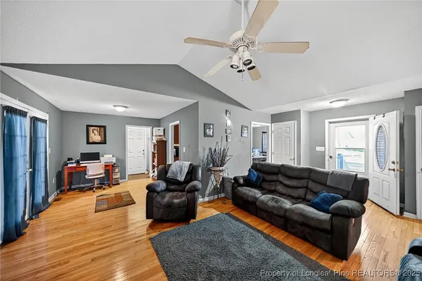 a living room with furniture wooden floor and window