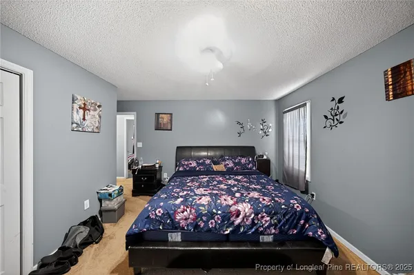 a bed sitting in a bedroom next to a window