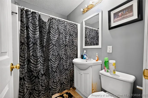 a white toilet sitting next to a bathroom sink