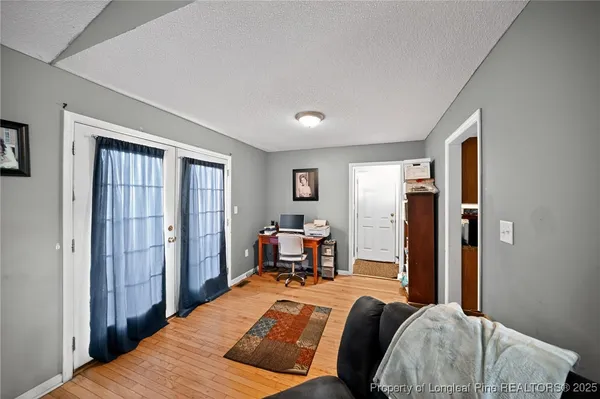 a bedroom with a bed and wooden furniture
