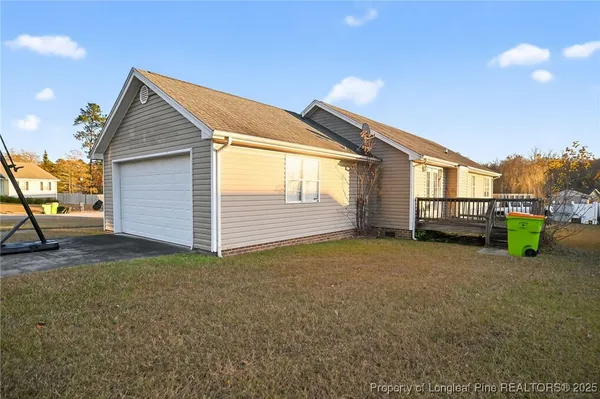 a view of a house with a backyard