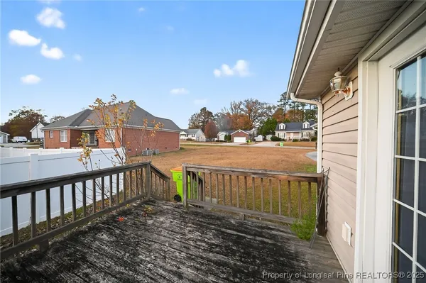 a view of a brick house with a small yard