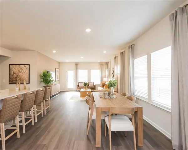 a view of a dining room with furniture window and wooden floor