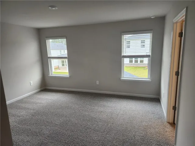 an empty room with a window and a fireplace