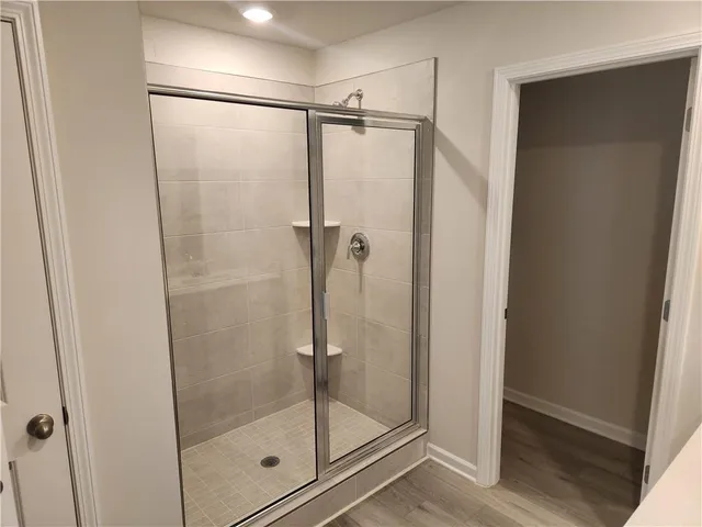 a bathroom with a glass shower door