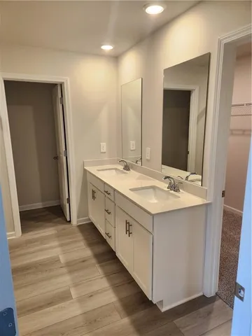 a spacious bathroom with a double vanity sink and a mirror