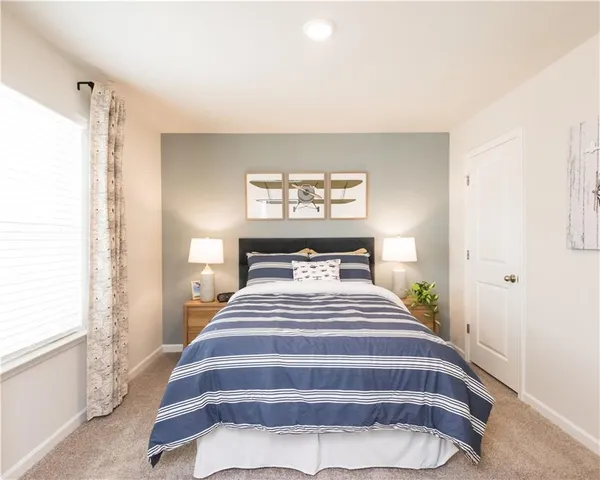 a bedroom with bed and window