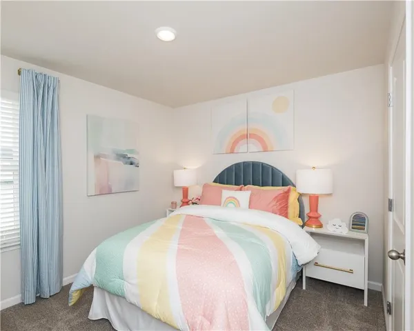 a bedroom with a bed and a painting on the wall