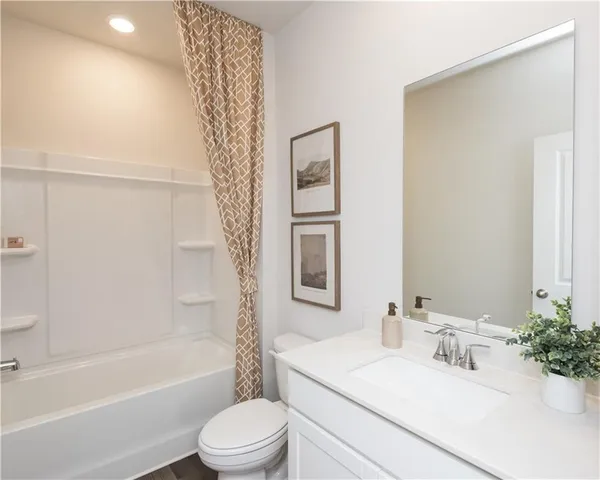 a bathroom with a sink a toilet a tub and shower