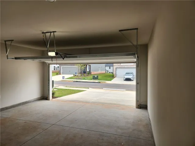 a view of room with refrigerator and ceiling fan