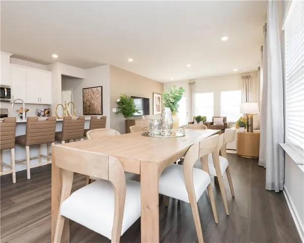 a large kitchen with lots of counter space a sink appliances and a dining table