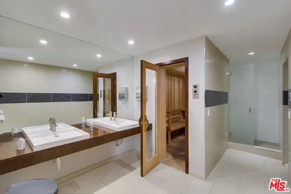 a bathroom with a double vanity sink and a mirror
