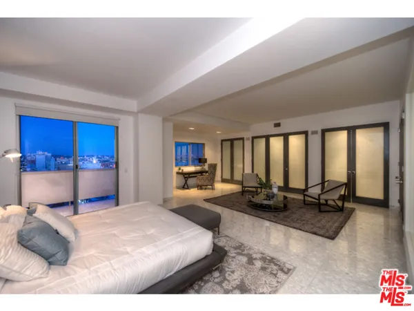 a bedroom with a large bed and a couch